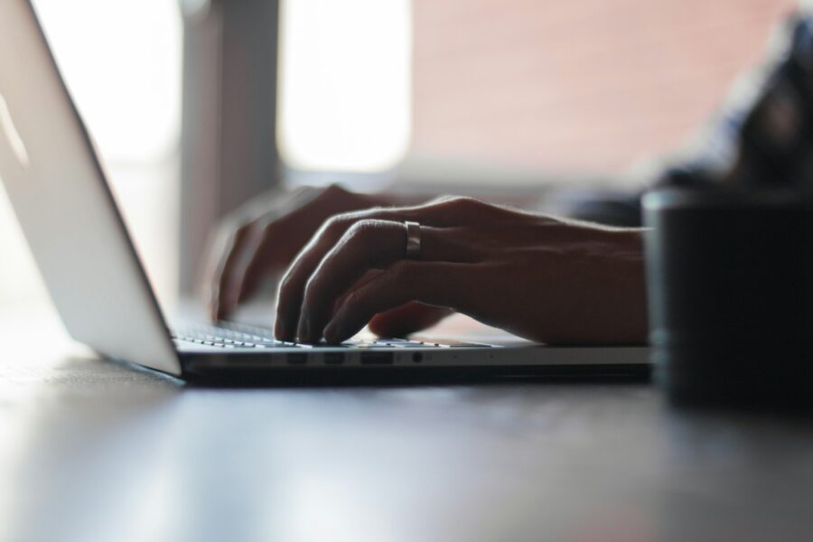 Person typing laptop