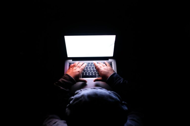 Hands typing laptop